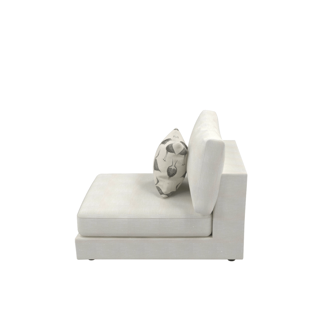 Side view of the Snowdrift Sectional Sofa Armless Unit Small in white upholstery, featuring a patterned pillow and highlighting minimalist luxury against a plain white background.