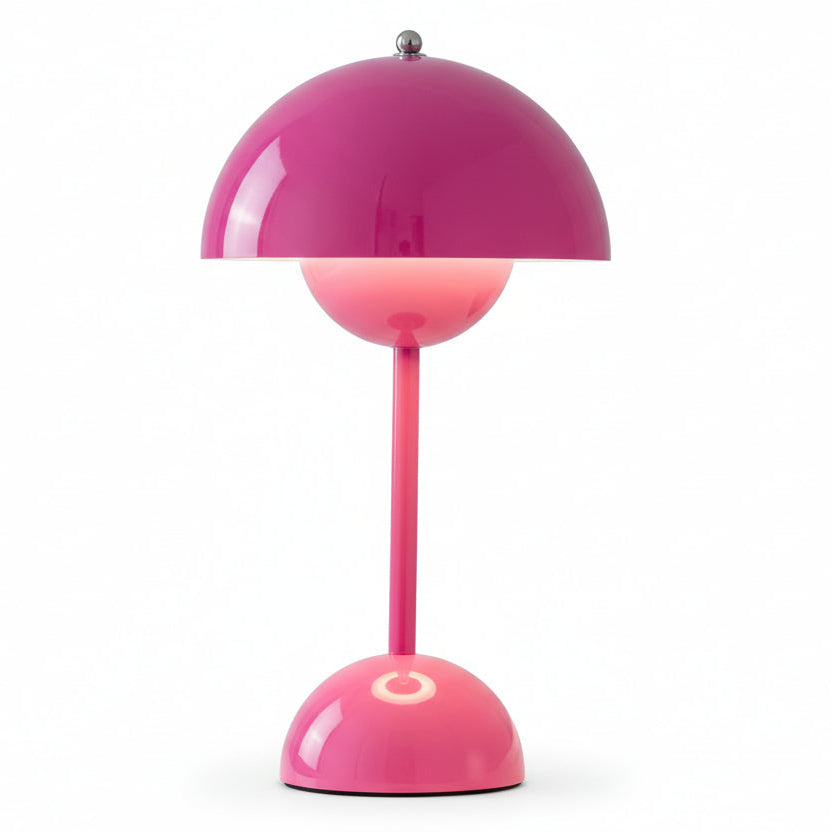 Two Cordless Bud Lamps, one in pink and one in metallic silver, are displayed side by side on a light surface. Both feature rounded shades and bases, each illuminated by a warm white LED bulb.