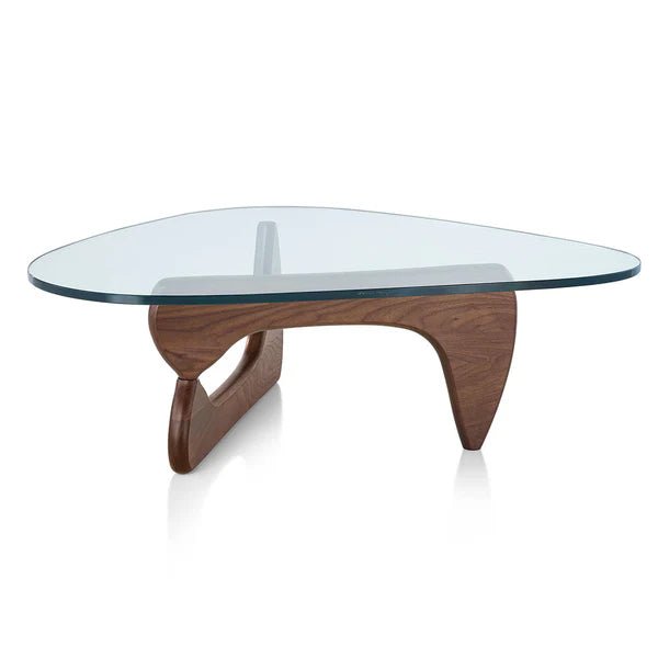 The Noguchi Coffee Table features a sculptural wooden base and an irregular triangular glass top.
