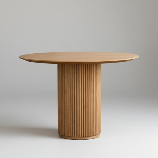 A Round Dining Table in Natural Wood Color features a flat top and a textured cylindrical base.