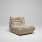 Beige lounge chair with cushions in a room setting