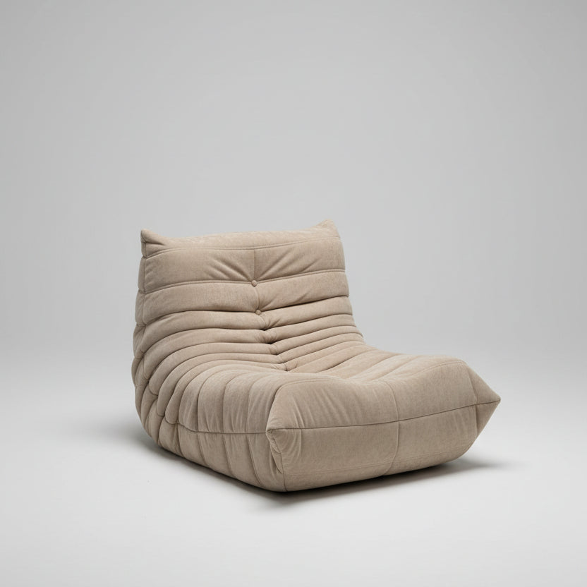Beige lounge chair with cushions in a room setting